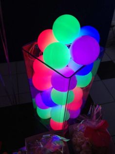 a vase filled with lots of bright colored balls