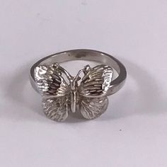 Dainty solid sterling silver, gold or platinum butterfly ring. Perfect for ladies or girls. This pretty butterfly comes in solid sterling silver, 10k, 14k or 18k gold or in platinum. If you choose gold for your ring, you can choose regular gold, white gold, rose gold or green gold (green in 14k or 18k only). Silver and platinum only come in the standard silver color. While puzzle rings are our specialty, we offer a wide range of non-puzzle rings and other jewelry in a variety of motifs. We carry Dainty Sterling Silver Butterfly Ring, Silver Ring With Butterfly Charm For Wedding, Silver Butterfly Ring For Formal Occasion, Silver Butterfly Jewelry For Formal Occasions, Sterling Silver Rings With Butterfly Charm, Silver Sterling Silver Ring With Butterfly Charm, Silver Sterling Silver Rings With Butterfly Charm, Silver Butterfly Ring Fine Jewelry Gift, Fine Jewelry White Gold Butterfly Ring As Gift