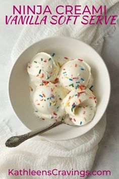 a white bowl filled with vanilla frosting and sprinkles