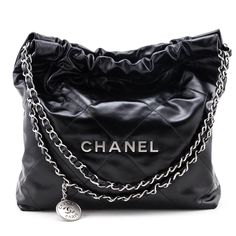 Irreverent cool with luxury finishing touches, this pristine Chanel 22 Bag is the current model you've been searching for! The high shine black calfskin exterior is finished with oversized flat diamond quilting, and matte silver-tone hardware. Front and center, individual hardware letters spell out CHANEL, set below the double interwoven leather & chainlink straps with a hanging branded medallion for added impact. The lightly cinched top, flat base, and soft structure create an edged up paper ba Chanel 22 Bag, Cinched Top, Chanel 22, Chanel Set, Versace Style, Authentic Designer Handbags, Chanel Purse, Chanel Paris, Purses Designer