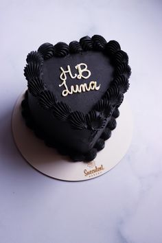 a heart shaped cake with the word b is for jama written in gold on it