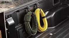 two hoses are attached to the side of a truck's door and in front of an oven