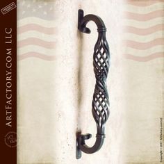 an old fashioned iron door handle with the american flag in the background