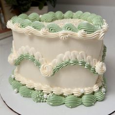 a white and green cake sitting on top of a table