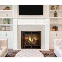 a living room filled with furniture and a fire place