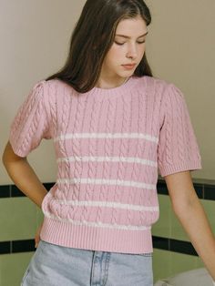 This product is a charming striped knit top that features a subtle marina-inspired design. The piece is crafted with a classic cable knit pattern, adding texture and depth to the lightweight fabric. Its short sleeves and snug ribbed hem offer a modern, fitted look while providing comfort and ease of movement. - The top's knit pattern is both traditional and stylish, suitable for various settings.- Its round neckline and short sleeves make it an ideal choice for spring and summer wardrobes.- The ribbed hem ensures the top maintains its shape and offers a polished finish.- The combination of the cable knit and stripe pattern gives this top a nautical feel with a contemporary twist. Striped Knit Tops With Short Sleeves, Striped Knit Sweater With Short Sleeves, Spring Striped Short Sleeve Knit Top, Striped Short Sleeve Knit Top For Spring, Casual Striped Pointelle Knit Tops, Spring Ribbed Short Sleeve Sweater, Ribbed Short Sleeve Sweater For Spring, Pink Cable Knit Crew Neck Top, Fitted Short Sleeve Cable Knit Tops