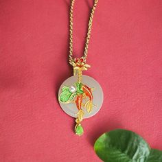 ⭐️ Introducing our Chinese vintage style pendant necklace that the pendant is made in synthetic jade that's in a light green color. Around the jade is a Koi fish decor. ⭐️ In Asian culture, koi fish represents luck and wealth. So this would be a very nice piece to keep or to gift with a lucky meaning behind it! ⭐️ The necklace is designed in a very vintage color that's unique and adorable to wear. The color is so elegant and simple that looks clean and easy to style.  ✈️ Handling & Shipping usually takes about 10 days in total, so please consider the processing time if it's a time sensitive gift.  🌹 We are trying our best to package your orders with love and care ❤️ Hope you understand our processing time!  ⚠️ Returns & Exchanges: We accept returns and exchanges within 7 days! Jade Necklace With Large Pendant For Gifts, Gold Jade Amulet Necklace, Green Necklace With Coin Pendant For Gift, Green Necklace With Coin Pendant As Gift, Green Coin Pendant Jewelry For Gift, Green Coin Pendant Jewelry As Gift, Jade Necklace With Lobster Clasp For Gift, Jade Necklace With Lobster Clasp As A Gift, Vintage Pendant Necklaces For Good Luck