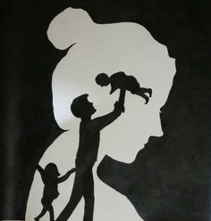 the silhouette of a man holding a child in his arms