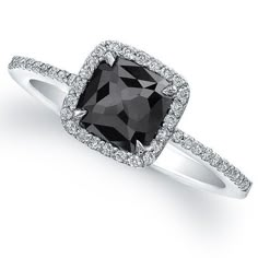 an engagement ring with a black diamond surrounded by diamonds