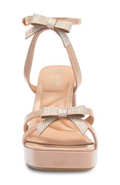 A chunky block heel elevates this party-ready sandal that's topped with slender straps and shimmering with crystallized bows. 3 1/2" heel; 3/4" platform Synthetic upper, lining and sole Imported Beige Party Heels With Bow, Beige Open Toe Sandals With Bow, Glamorous Pink Sandals With 4-inch Heel, Champagne High Heel Sandals With 4-inch Heel, Gold Sandals With 4-inch Heel In Synthetic Material, Steve Madden Sneakers, Crystal Shoes, Chunky Block Heels, Flip Flop Slippers