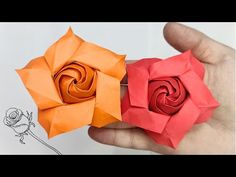 two origami roses being held in their hands