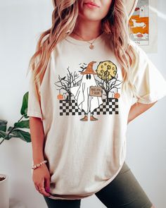 PLEASE NOTE, DUE TO THE BUSY HOLIDAY SEASON ANY ORDERS PLACED AFTER 12/09/24 ARE NOT GUARANTEED TO ARRIVE BY CHRISTMAS.Looking for a comfortable, cute fall shirt that will make you stand out from the crowd? Look no further than our Comfort Colors Funny Ghost t-shirt! Give it as a gift to your friends and family this fall season, or wear it yourself to show your support for all things Halloween. Comes in multiple colors! Check out more designs here: www.etsy.com/shop/jadeandroseshop ✨️SIZE AND FI Fall Cotton T-shirt With Character Print, Cute Pre-shrunk Shirt For Fall, Funny White T-shirt For Fall, Casual Fall Shirt With Cartoon Print, Fall Cotton Shirt With Cartoon Print, Funny Cotton Tops For Fall, White Tops With Character Print For Fall, Fun Fall T-shirt With Funny Print, Fall Crew Neck Shirt With Funny Print