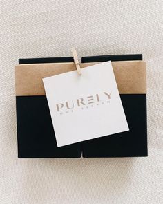 a black and white box with a tag on it that says purey university