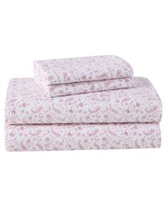 three sheets with pink flowers and birds on them, one is folded up to the side