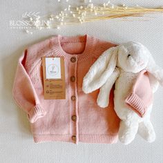 Child's pink-colored sweater with front buttons. Made with soft cotton fiber and a comfortable and classic design with a round neck and ribbed cuffs on sleeves and waist. This cardigan is perfect for a baby gift or to buy for a little one on a special day. The style and neutral color palette make it versatile to mix and match with different clothes. EVERLY CARDIGAN PINK 100% cotton knitted Cardigan. Crew neck, stretchable cuffs.  Sturdy buttons positioned at front. Doesn't cause irritation. Support machine wash. We design garments for babies and little girls from 0 to 6 years old. We accompany each product with a delicate packaging specially designed for a very special gift. Our line of linen dresses, like all our garments, are exclusive, handmade, made only by our brand Blossomline. Care Easter Sweaters, Coat For Fall, Cardigan Rosa, Rose Cardigan, Pull Rose, Girls Fall, Toddler Fall, Cardigan Pink, Toddler Clothing