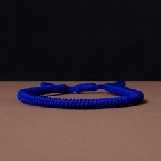 "◾ The handmade navy blue Tibetan bracelet for luck and protection is a beautifully crafted accessory, each knot is meticulously tied whos creates an amazing pattern. ✅ Adjustable bracelet - the slip knot lets you adjust the size. ➰ Sizes: S - Fully Closed - 5.9\"inches (15cm) / Full Opened - 9.8\"inches (25cm) M - Fully Closed - 6.6\"inches (17cm) / Full Opened - 10.6\"inches (27cm) L - Fully Closed - 7.4\"inches (19cm) / Full Opened - 11.4\"inches (29cm) 🟦 The color of the bracelet is navy blue. ◽ More colors and models are available in the shop. ◽ Just check out the shop. ✔️ Please note that due to the difference between different monitors, the image may not reflect the actual color of the item. ✍ If you have any questions please contact me." Adjustable Blue Spiritual Braided Bracelet, Blue Braided Friendship Bracelets, Spiritual Handmade Blue Braided Bracelets, Blue Spiritual Bracelet With Sliding Knot, Blue Spiritual Bracelets With Sliding Knot, Adjustable Blue Woven Braided Bracelet, Adjustable Blue Braided Bracelet, Blue Resizable Spiritual Friendship Bracelets, Resizable Blue Spiritual Friendship Bracelet