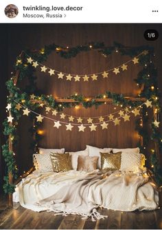 an image of a bed decorated with christmas lights and garlands on the headboard