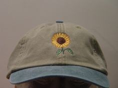 NEW EMBROIDERED SUNFLOWER AUTUMN GARDEN BASEBALL FLOWER HAT HATS PICTURED ARE KHAKI/FOREST GREEN, KHAKI/NAVY BLUE AND KHAKI/ROYAL BLUE Adams Optimum 6 Panel Baseball Hat Low Profile - 100% Cotton Twill Adult Cap Pigment Dyed - Garment Washed Hat 6 Panels with Sewn Matching Eyelet Visor with 3 Rows of Stitching Pre-formed Bill - Leather Strap with Brass Grommet Adjustable - One Size Fits Most An Extremely Comfortable Baseball Hat! Enjoy the Embroidered Sunflower Fall Garden Baseball Flower Hat Pl Spring Outdoor Baseball Cap With Embroidered Logo, Casual Summer Hats With Custom Embroidery, Outdoor Baseball Cap With Embroidered Logo For Spring, Spring Baseball Cap With Embroidered Logo, Spring Outdoor Hat With Embroidered Logo, Spring Baseball Cap With Embroidered Logo And Short Brim, Casual Embroidered Sun Hat With Curved Brim, Casual Embroidered Hat With Short Brim, Casual Embroidered Short Brim Hat