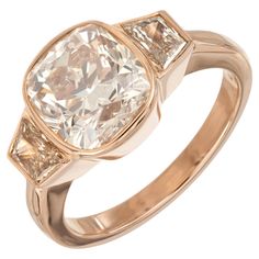 a gold ring with two diamonds on it