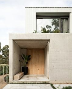 an entrance to a house with concrete walls