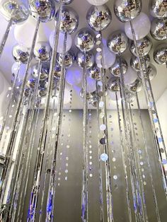 a large chandelier with lots of shiny balls hanging from it's ceiling