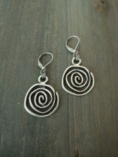 Bohemian Silver Spiral Earrings    These earrings are versatile and comfortable to wear. They will go with almost any outfit. They are great for gift giving or as a treat for yourself. 🌻 Measurements: The focal spiral charm is approximately 1 inch in diameter. The earring drop size/diameter is approximately 1.10 inch. (if choosing bean hooks, please see below.) The earring's total size (with the hooks included) is around 1.50 inch. With bean hooks: all the sizes will increase by 1 inch.  These earrings will be approximately 2 inches in total length with bean hooks. ⭐Colors may slightly vary due to the differences in screen monitor settings vs. real life lightings. Shipping:   I ship within 2 business (non-holiday) days of the purchase. The shipping service I use is First Class Package off Metal Spiral Wrap Single Earring, Metal Spiral Wrap Earrings, Spiral Metal Wrap Earrings, Spiral Metal Earrings, Handmade Bohemian Swirl Earrings, Nickel-free Spiral Wrap Earrings, Metal Spiral Earrings With Ear Wire, Spiral Metal Earrings With Ear Wire, Metal Swirl Earrings With Ear Wire