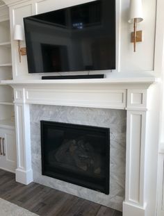 a fireplace with a flat screen tv above it