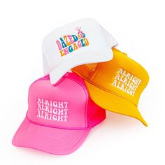 three different colored hats with the words alright alright alright on them, all in white and pink