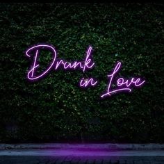 a pink neon sign that reads, drank on love