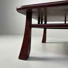 a wooden bench sitting on top of a white floor