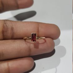 14k solid yellow gold natural emerald cut shaped garnet gemstone ring. 1. The weight of the natural garnet gemstone used in the ring =0.55 cts. 2. The weight of the 14k solid yellow gold used in the ring =0.880 grms. 3. The garnet is the birthstone for the people born in the month of January. 4. The design of the ring is very nice and beautiful. 5. I have used all my skills and experience to manufacture this ring as beautiful as I can and I do hope that my work will be appreciated. Thanks Yellow Gold Emerald Cut Ruby Ring Gift, Emerald Cut Ruby Ring In 14k Gold, Emerald Cut 14k Gold Ruby Promise Ring, Emerald Cut Garnet Rings For Gift, Emerald Cut Garnet Rings As Gift, Emerald-cut Garnet Gemstone Rings, Emerald Cut Garnet Gemstone Rings, 14k Gold Ruby Ring With Bezel Setting, Emerald Cut, Yellow Gold Ruby Ring With Emerald Cut