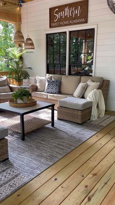 a living room filled with furniture on top of a hard wood flooring covered porch