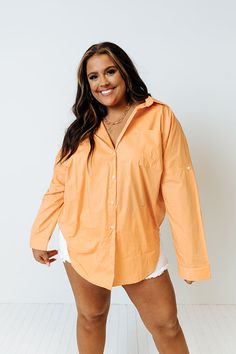 Channel all the good luck on your special day with this casual cute orange plus size top featuring lightweight material, a button up front with a collared neckline, long loose sleeves with roll tab cuffs, a single accent chest pocket, and a relaxed silhouette that falls into a rounded hemline!   Measurements 1XL variant has  a Bust of 58",  a Hip of 54",  a Length of 35",  a Sleeve Length of 15",  a Waist of 53".  2XL variant has  a Bust of 60",  a Hip of 55",  a Length of 36",  a Sleeve Length Oversized Orange Long Sleeve Shirt, Oversized Orange Shirt With Long Sleeves, Orange Long Sleeve Blouse With Relaxed Fit, Oversized Long Sleeve Orange Blouse, Orange Relaxed Fit Long Sleeve Blouse, Oversized Orange Long Sleeve Blouse, Trendy Orange Long Sleeve Shirt, Orange Collared Blouse For Spring, Spring Orange Collared Blouse