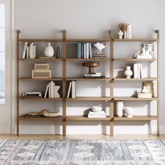 a bookshelf filled with lots of books on top of a wooden shelf next to a window