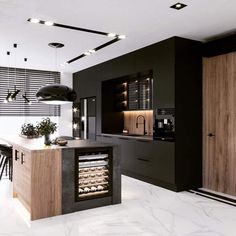 a modern kitchen with black cabinets and marble counter tops, an oven in the center