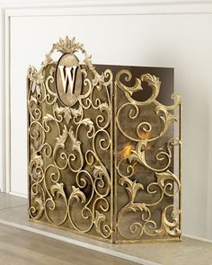 an ornate gold metal screen with the letter w on it's front and side panels