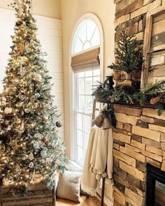 This rustic living room features a pine tree and garland on the dark wood mantel of a stone fireplace. A tree with gold Christmas tree decorations stands in front of an off-white wall with tall white shiplap wainscoting. A rustic wood box is placed on the warm wood floor...   Image: ourrustichaven Silver Gold Christmas, White Tree Skirt, Rose Gold Christmas Tree, Warm Wood Flooring, Rustic Wood Box, Gold Christmas Tree Decorations, Off White Walls, White Shiplap Wall, Gold Christmas Ornaments