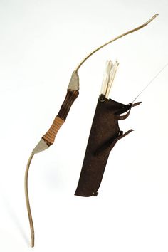 two pieces of cloth hanging from strings on a white background with one piece being held back by a string