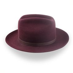 Description Materials Craftsmanship Hat Care Shipping Returns Product Description A Burgundy Western Fedora with Leather Hat Belt Step into sophistication with the Patriot, a burgundy western fedora handcrafted from premium rabbit fur felt. Featuring a unique 5 1/2" cattleman crown and a 3" snap brim, this hat blends traditional Western style with modern elegance. The artisanal leather hat belt adds a touch of rugged charm, while the genuine leather sweatband ensures comfort and durability. Cust Mens Felt Hats, Spanish Hat, 1940 Style, Homburg, Personalized Hats, Trilby Hat, Leather Hat, The Patriot, Classic Hats