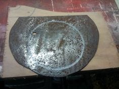 an old frying pan sitting on top of a wooden table