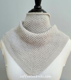 a white mannequin wearing a silver knitted collar