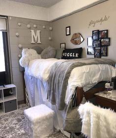 a dorm room with two beds and pictures on the wall above them, along with other decorations