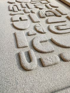 the letters are made out of sand on the ground