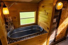 the inside of a wooden cabin with a large jacuzzi tub