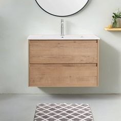 a bathroom with a sink, mirror and rug