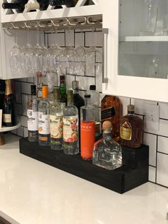 bottles and glasses are lined up on the counter