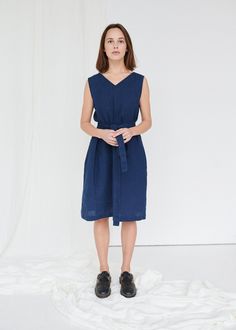 "SIZING & FIT This garment is true to size, and we recommend choosing the size you usually wear. If you want the garment to be loose-fitting, choose a larger size than you usually wear. Before placing an order, check the approximate measurements of the finished garment given below. Model is 5′6″ (170cm) tall with a 80cm/31″ bust, 68cm/26″ waist, 91cm/35″ hip, and she is wearing an XS in navy blue. XXS Length ± 105cm | 41.3\" Bust ± 92cm | 36.2\" Armhole ± 44cm | 17.3\" Hem width ± 134cm | 52 Spring V-neck Ramie Dress, Indigo V-neck Summer Dress, Linen V-neck Sleeveless Sundress, Linen V-neck Sundress Midi Dress, Navy V-neck Midi Dress For Summer, Blue Linen V-neck Dress, Blue Linen Midi Length Dress, Blue Midi Linen Dress, Summer Indigo Linen Dress