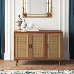 a wooden cabinet with wicker doors and a mirror on the wall in front of it