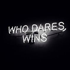 a neon sign that says who dares wins