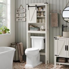 a white toilet sitting next to a bathroom sink